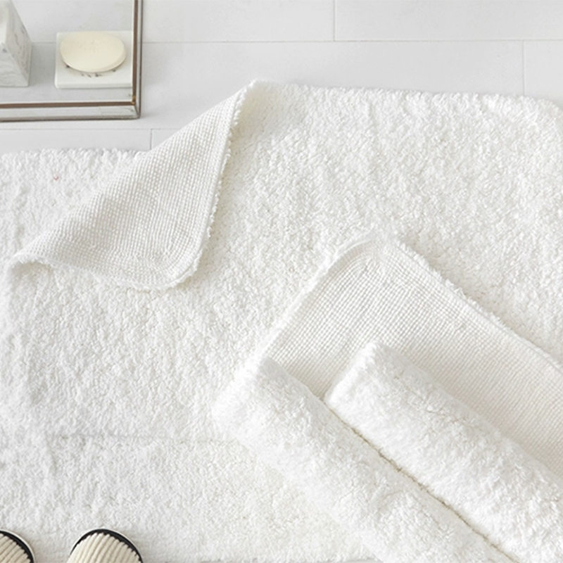 Why is the Pure cotton long plush pile hotel bath rug softer and thicker than traditional bathroom mats?